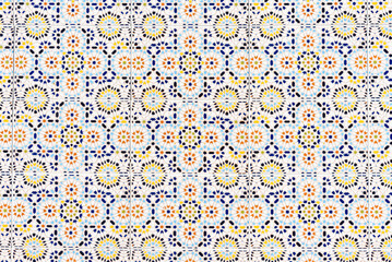 Old traditional ceramic azulejos tiles pattern on the house exterior. Abstract colorful floral...