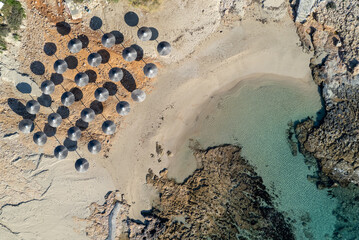 Drone aerial of beach umbrellas in the beach. Summer holidays in the sea.