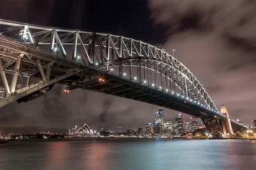 Photo sur Plexiglas Sydney Harbour Bridge Sydney Harbour Bridge and Opera House at Night. Beautiful Sydney Cityscape and Skyline. Long Exposure. Flowing Sky. Australia