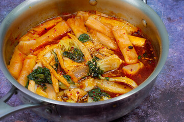Tteokbokki- korean rice cakes simmered in a spicy sauce.