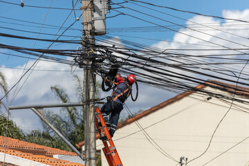 Telecommunication and power cables, technician working on street telegraph pole, Equipment maintenance, telegraph cables