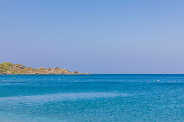 Fototapeta premium Beautiful view of blue water of Mediterranean sea against backdrop of mountains. Greece.