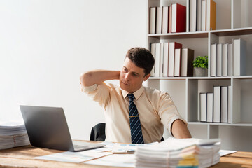 young businessman are stressed while working on laptop, Tired young businessman with headache at office, feeling sick at work