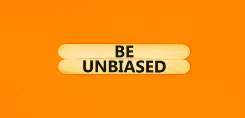 Be unbiased symbol. Concept words Be unbiased on wooden sticks. Beautiful orange table orange...