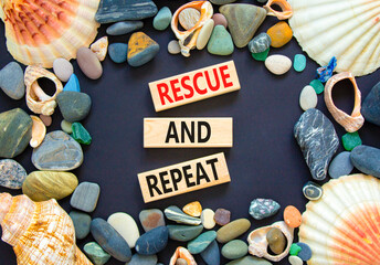 Rescue and repeat symbol. Concept words Rescue and repeat on wooden block on a beautiful black...