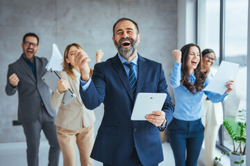 Successful businesspeople having a meeting in an office. Business concept. Business meeting office conference team teamwork. Business People Celebrating with arm raised up