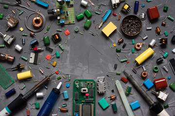 Different electronic components and equipment. flat lay with space for text on gray concrete background. set of spare parts DIY.