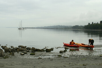 Launching colorful red kayaks a, Port Angeles, Washington 