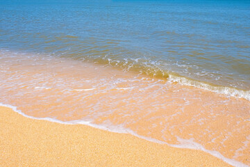 The coast of the Sea of Azov. Sea waves roll on the sandy shore. Seashell sandy beach.