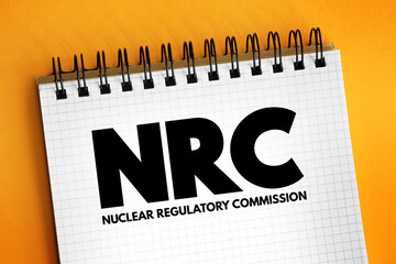 NRC - Nuclear Regulatory Commission acronym text on notepad, abbreviation concept background