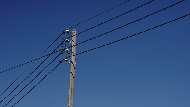 low voltage electric pole against the sky