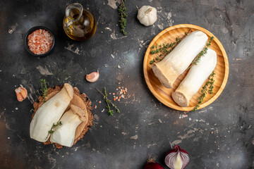 Fresh King Oyster Mushroom, Pleurotus eryngii on a dark background, banner, menu, recipe place for text