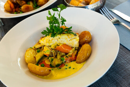 Hake fillet with vegetables and potatoes. French dish. High quality photo