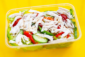 Salad with shredded chicken and vegetables in plastic package box