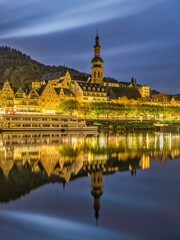 Fototapeta na wymiar Cochem riverside buildings lit up after sunset and lights reflection on Moselle river in Cochem-Zell district in Rhineland-Palatinate, Germany