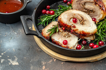 Roll of meat with various spices and berry sauce on a dark background. banner, menu, recipe place for text, top view