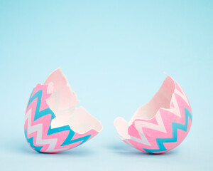 Pink and blue Easter egg open and cracked in half. Empty copy space for text or product. - 581245788