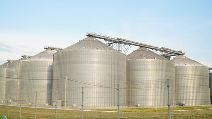 Grain storage. Grain storage elevator. Large metal hangar for grain. Silo with grain