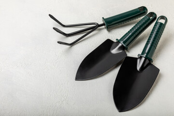 Garden tools on the background of a concrete table. Garden shovels, rakes and secateurs. Top view. Flat lay. Concept of gardening or planting. Work in the spring garden.