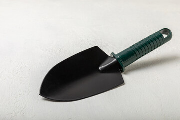Garden tools on the background of a concrete table. Garden shovels. Top view. Flat lay. Concept of gardening or planting. Work in the spring garden.
