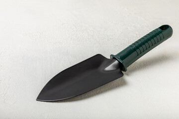 Garden tools on the background of a concrete table. Garden shovels. Top view. Flat lay. Concept of gardening or planting. Work in the spring garden.