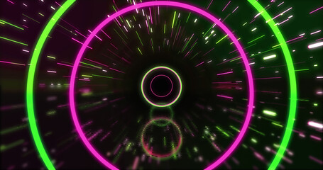 Image of green and pink neon circles and light trails on black background