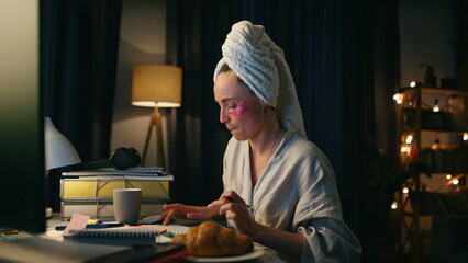 Positive woman typing computer closeup. Smiling bathrobe lady relaxing with pc