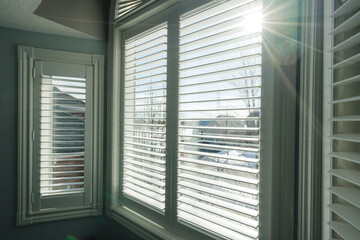 View of Bedroom with Window Shutter Blinds with Sunflares