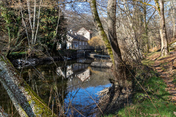Fototapeta na wymiar A house on the bank of the river Sedelle in Creuse, France.