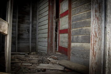 Fototapeta na wymiar Abandoned house with red door