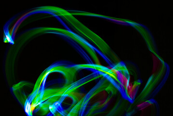 Abstract light shapes on dark background without the use of photoshop. Light effects generate a light painting photography.