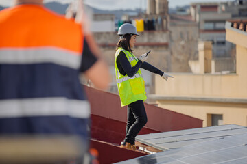 Electrician architect woman pointing away, using walkie talkie to communicate to worker during...