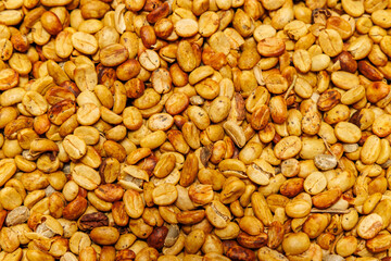 Coffee beans in various stages of roasting at a coffee plantation