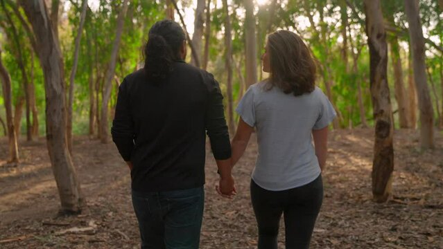 Young Couple Holding Hands and Walking