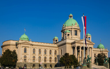 Fototapeta na wymiar Parliament of Serbia in Belgrade, building of the National Assembly of the Republic of Serbia with a national flag