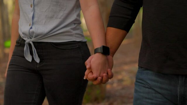 Young Couple Holding Hands and Walking