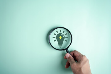 Magnifier focus to green electricity icon decrease CO2 or carbon dioxide emission, carbon footprint...