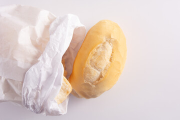 Fresh French Bread Loaf from a Bag, top view, white background