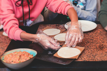 Group of children in a cooking class, kids preparing asian style food in the kitchen together, kids...