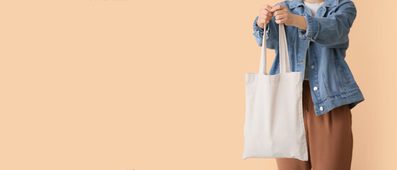 Woman with eco bag on beige background with space for text