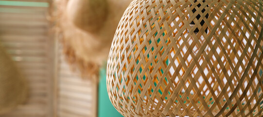 Rattan ceiling lamp in room, closeup