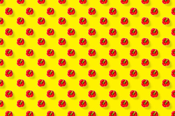 Bulgarian red ripe pepper on yellow backdrop. background from paprika, flat lay not seamless pattern