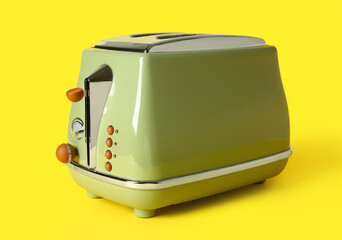 Modern toaster on yellow background