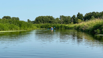 woman kayaking the lake during summer
