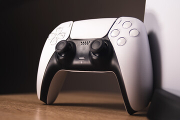 last generation video game controller, white with black color, horizontal position
