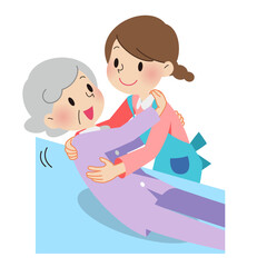 おばあさんを抱き起す介護士の女性