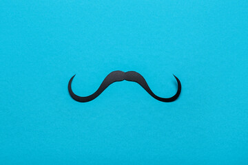 Paper mustache on color background. Father's Day celebration