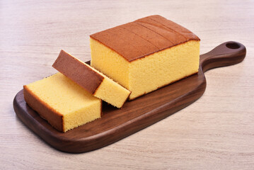 Castella (kasutera) - Delicious sliced honey sponge cake on wooden plate