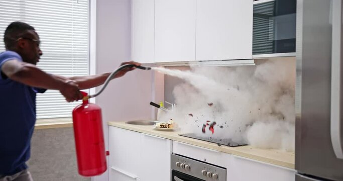 Man Using Fire Extinguisher To Stop Fire