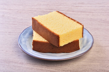 Fototapeta na wymiar Castella (kasutera) - Delicious sliced honey sponge cake on a plate 